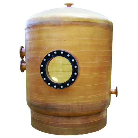 Shown in the center of a white background, mermade filter's fiberglass surge and balance tank for commercial pool applications. It is a tall cylinder with a domed top, a large manway and two pipe connections on the left and one pipe connection on the right